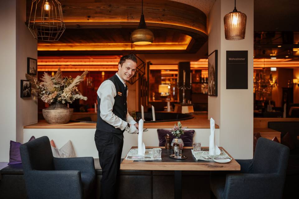 Kellner deckt Tisch ein im Restaurant Alpenresort Schwarz
