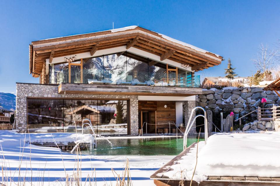 verschneiter Naturbadesee im Alpenresort Schwarz